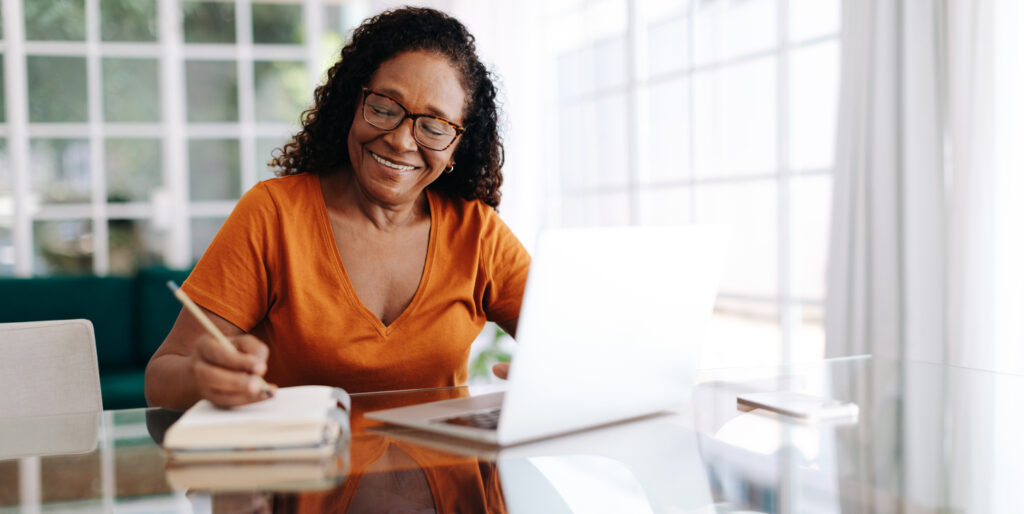 a smiling woman creating a sales proposal